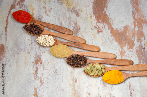 Fototapeta Naklejka Na Ścianę i Meble -  Aromatic spices on wooden spoons. Food ingradients.



