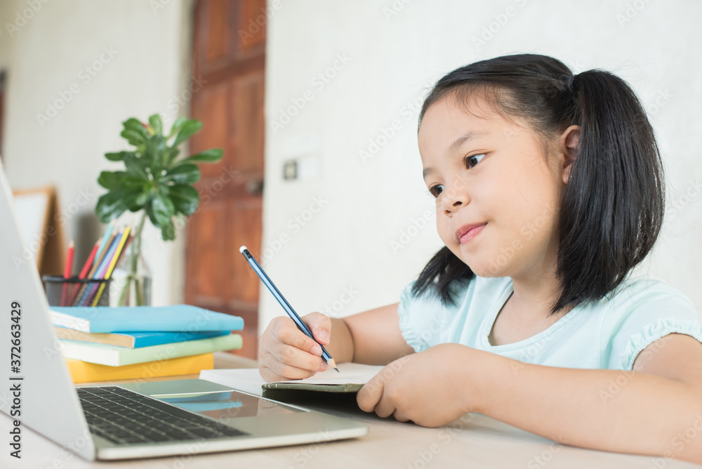 pretty stylish schoolgirl studying homework during online lesson at home, social distance during quarantine, self-isolation, online education concept, home school, study online video call teacher. pretty stylish schoolgirl studying homework during online lesson at home, social distance during quarantine, self-isolation, online education concept, home school, study online video call teacher.