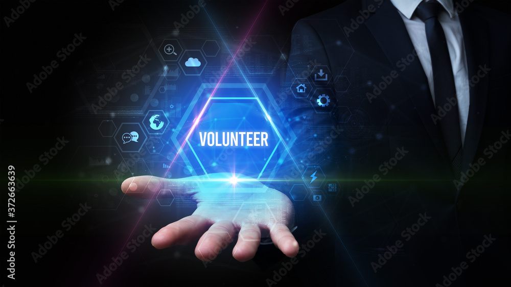 Man hand holding VOLUNTEER inscription, social media concept Man hand holding VOLUNTEER inscription, social media concept