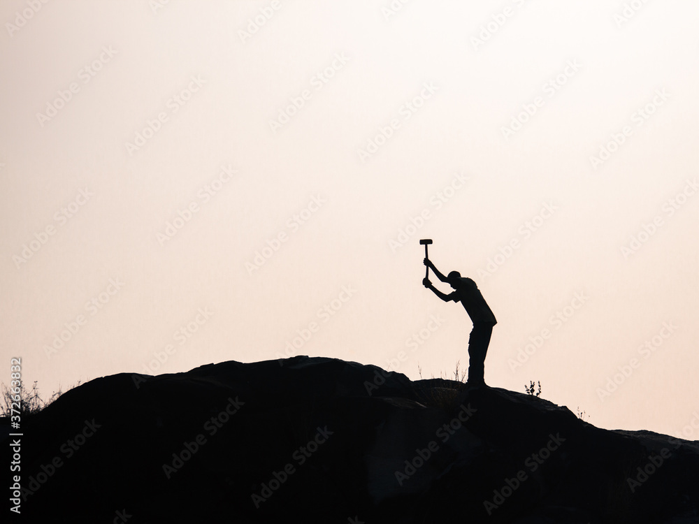 Man breaking rocks with hammer in Africa
