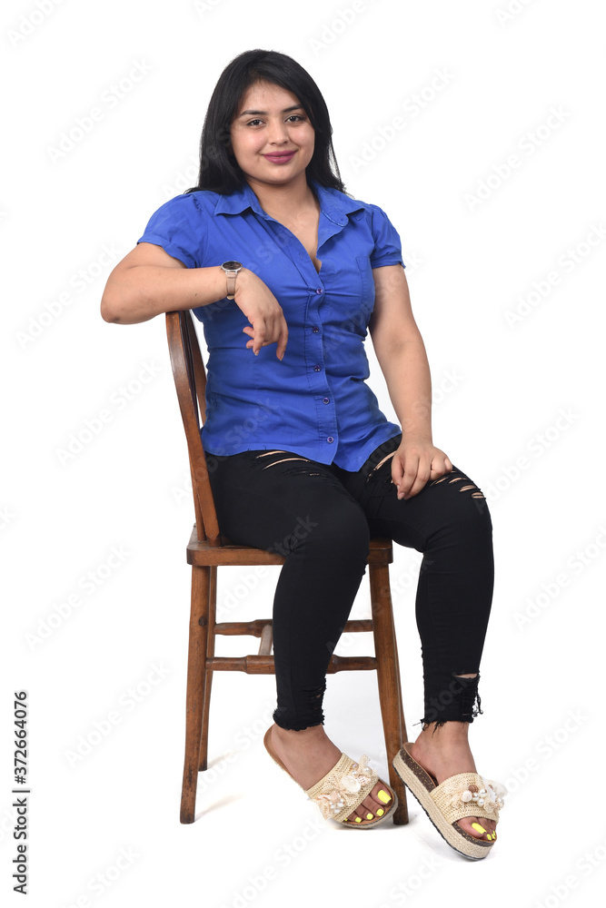 portrait of a latein woman  sitting on a chair in white background,