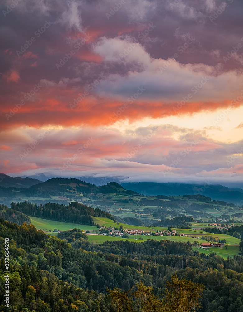 Bern during sunset with colorful sky and nice cloudscape. European mountain landscape, Switzerland, Bern.