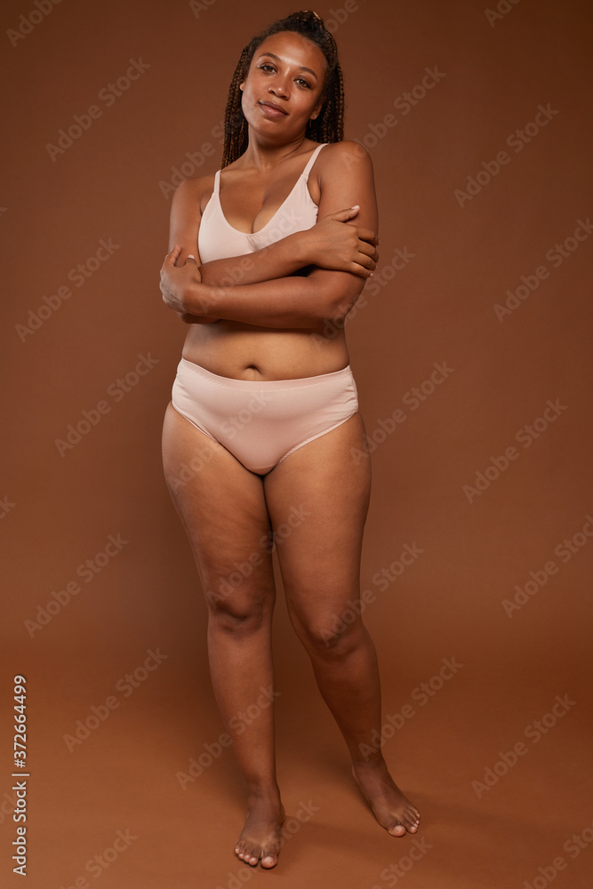 Foto de Portrait of African woman in underwear with beautiful body smiling  at camera do Stock