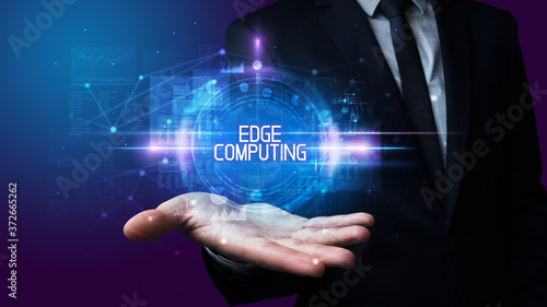 Man hand holding EDGE COMPUTING inscription, technology concept