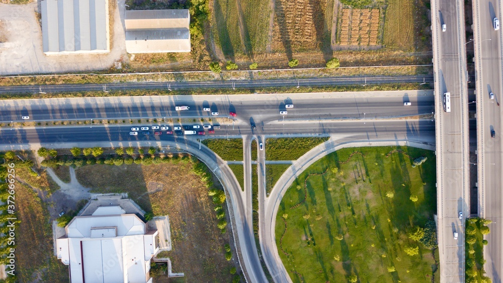 Aerial view of two lane bridge driveway. There is an inner ring road at the bottom. Vehicles and commercial vehicles can also be seen.	
