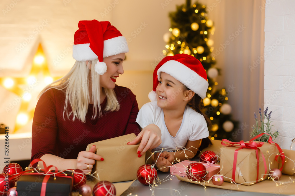 holidays, presents, christmas, x-mas, birthday concept - happy mother and child girl with gift box holidays, presents, christmas, x-mas, birthday concept - happy mother and child girl with gift box