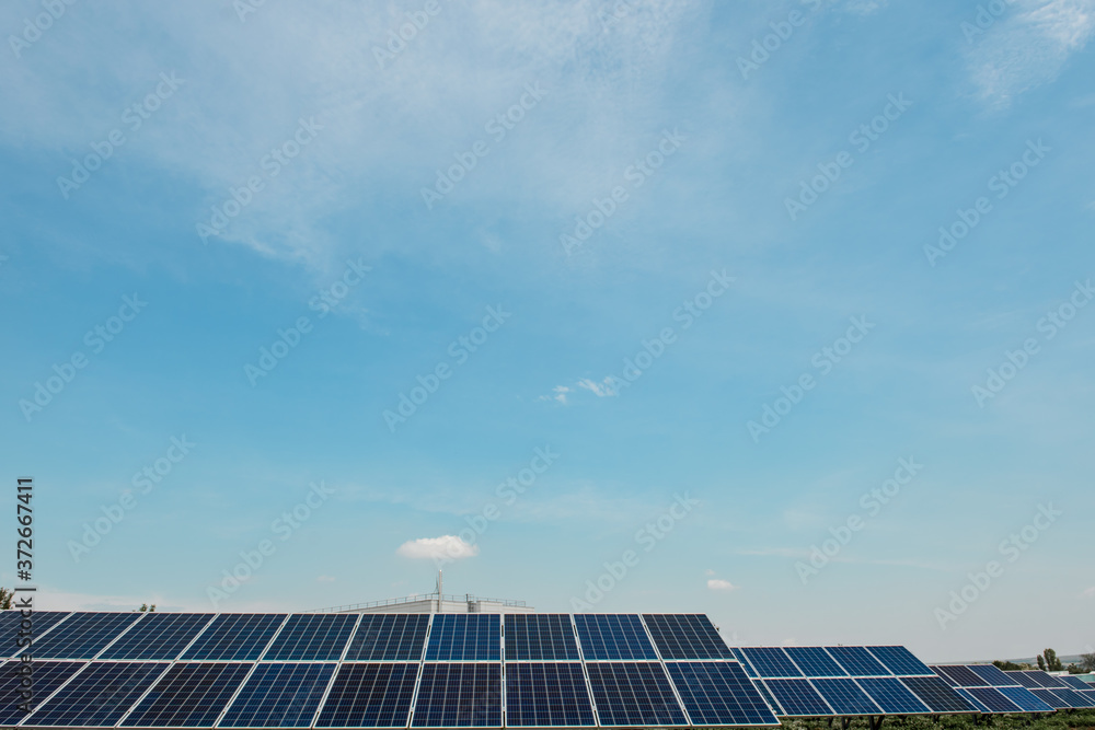 Photovoltaic power plant. Solar photovoltaic panels on blue sky background Photovoltaic power plant. Solar photovoltaic panels on blue sky background
