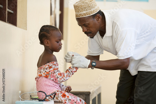 Doctor examining girl in clinic