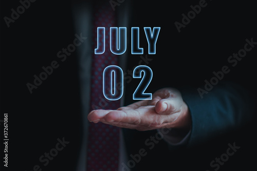 Wallpaper Mural july 2nd. Day 2 of month, announcement of date of  business meeting or event. businessman holds the name of the month and day on his hand.. summer month, day of the year concept Torontodigital.ca