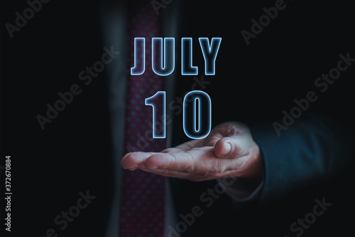 Wallpaper Mural july 10th. Day 10 of month, announcement of date of  business meeting or event. businessman holds the name of the month and day on his hand.. summer month, day of the year concept Torontodigital.ca