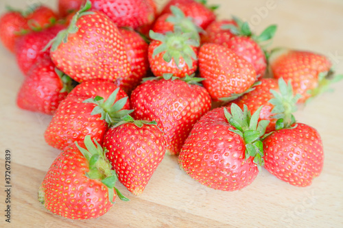 Strawberries on wooden table  natural light