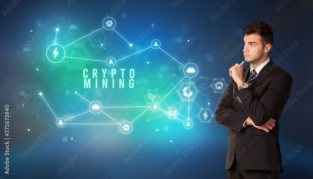 Businessman in front of cloud service icons with CRYPTO MINING inscription, modern technology concept Businessman in front of cloud service icons with CRYPTO MINING inscription, modern technology concept