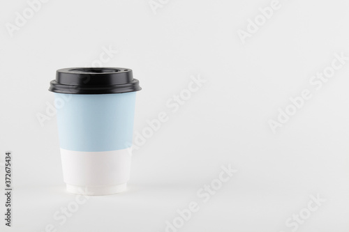 take away paper cup for coffee or tea on white background. copy space. minimal coffee concept.