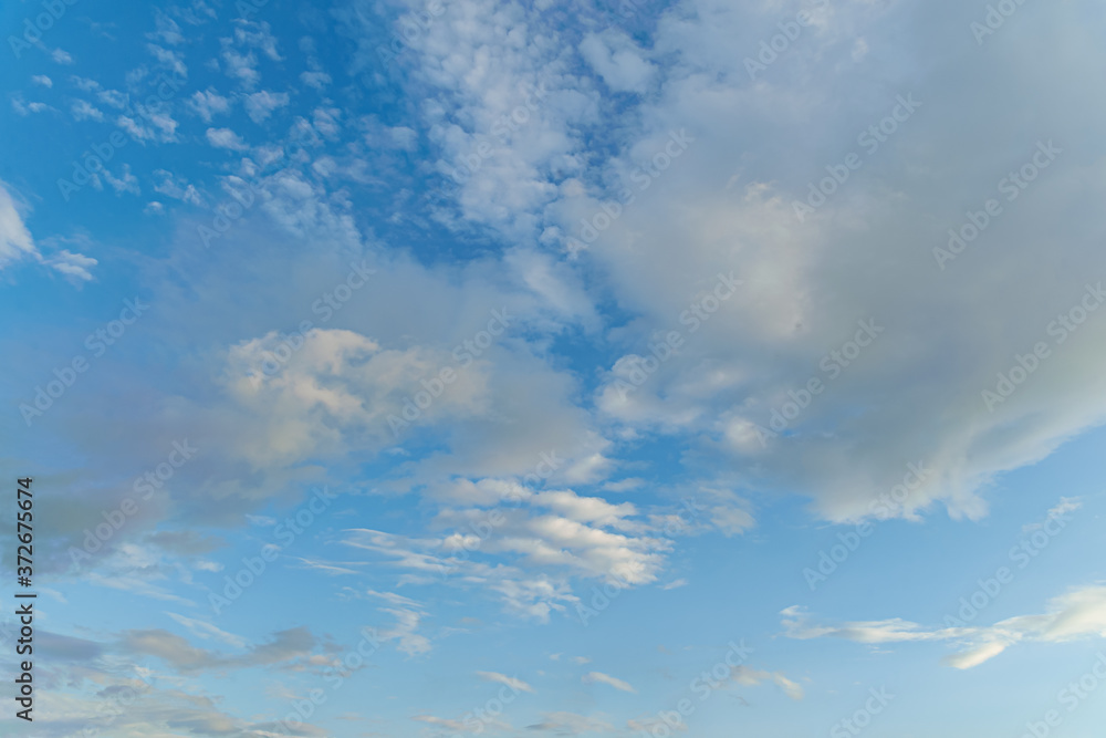 abstract background of white fluffy clouds on a bright blue sky