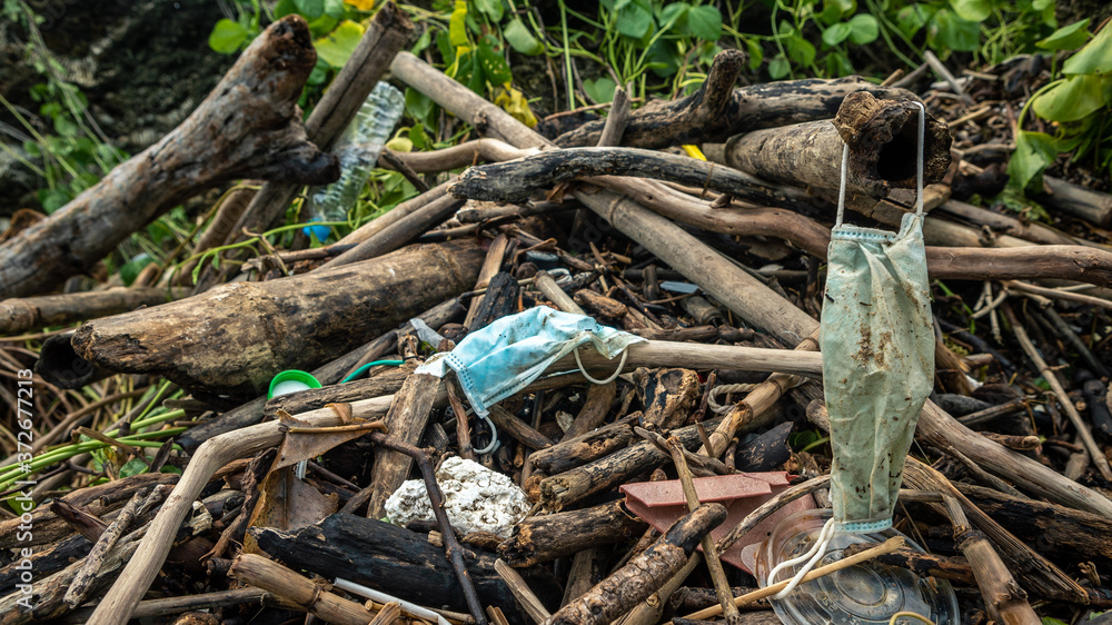 Garbage from used medical masks and gloves on the beach. Pollution ocean Garbage from used medical masks and gloves on the beach. Pollution ocean