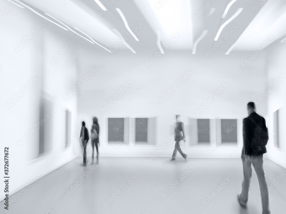 people in the art gallery center in monochrome blue tonality people in the art gallery center in monochrome blue tonality