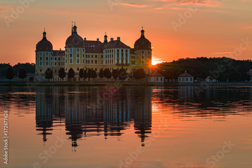 Beautiful evening panorama of Moritzburg Baroque palace surrounded by a lake. © scimmery1
