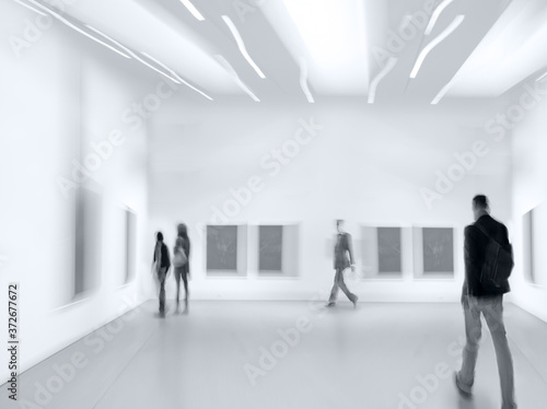 people in the art gallery center in monochrome blue tonality photo