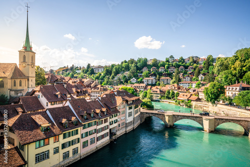 Scenic cityscape of Bern at sunset with untertorbrucke bridge over Aare river and Nydegg church view with dramatic light in Bern old town Switzerland