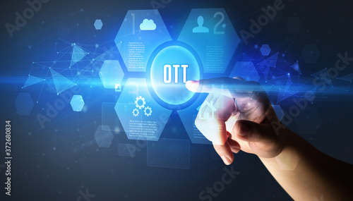 Hand touching OTT inscription, new technology concept