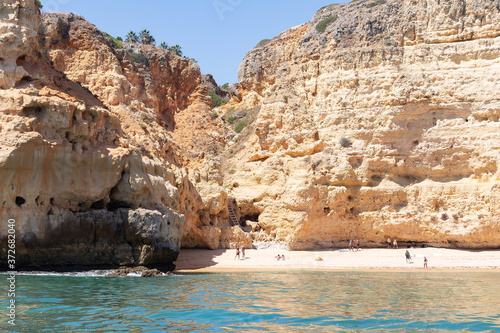 View from the sea of Carvoeiro beach. The Lagoa region has a coastline formed of towering cliffs, turquoise waters and picturesque beaches. The beaches of Carvoeiro are found within sheltered coves photo