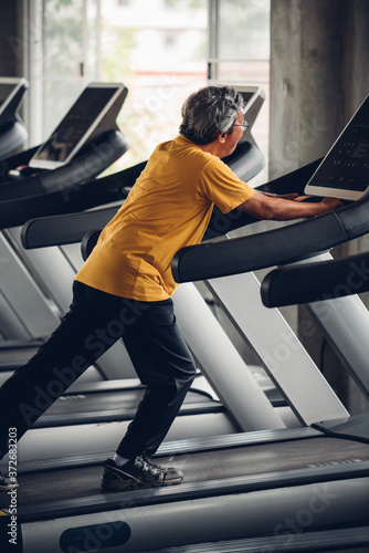 Senior Man Exercising In Gym