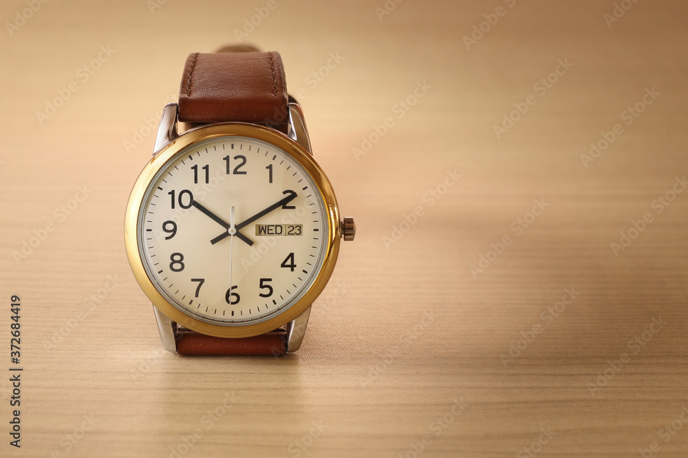 Wristwatch on wooden table Wristwatch on wooden table
