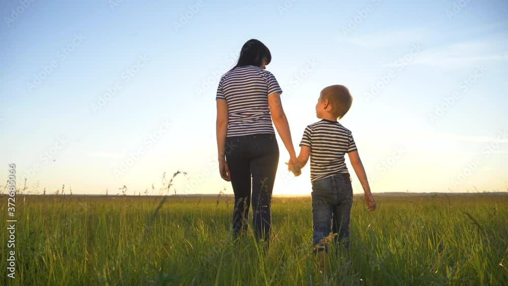 Happy family together.Mother and son walk in the open air in the countryside, lead a healthy lifestyle.The concept of teamwork, family reunion. Happy family together.Mother and son walk in the open air in the countryside, lead a healthy lifestyle.The concept of teamwork, family reunion.