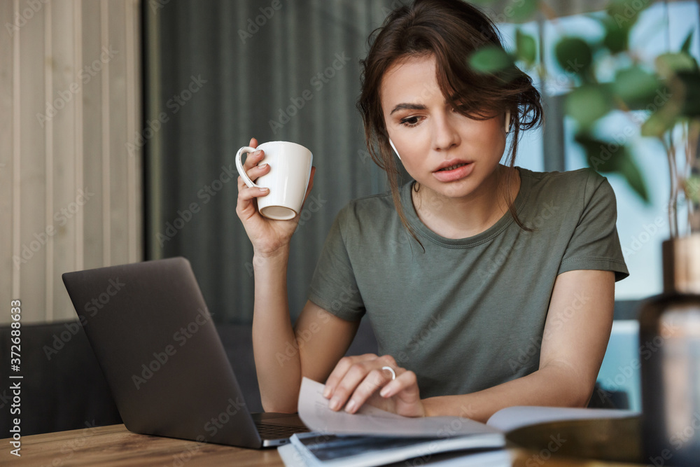 Attractive young woman working on laptop computer Attractive young woman working on laptop computer