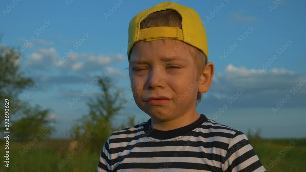 The isolated child is hysterical, tears flow down his face. The boy screams plaintively shows a capricious character. The concept of family education, loneliness, poverty and hunger. Homeless child. The isolated child is hysterical, tears flow down his face. The boy screams plaintively shows a capricious character. The concept of family education, loneliness, poverty and hunger. Homeless child.