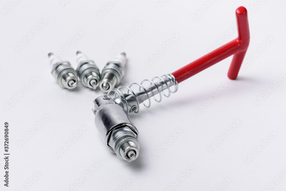 Car spark plugs and key on white background Car spark plugs and key on white background