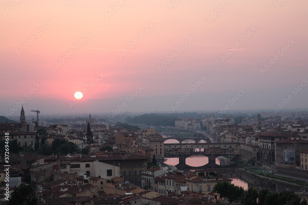 Landscape of Florence with Ponte Vecchio bridge seen from Michelangelo square during sunset in Florence Tuscany, Italy