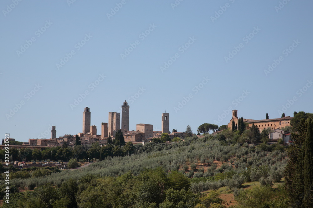 View of San Gimignano skyline with wine countryside landscape in San Gimignano, Siena province, Tuscany, Italy View of San Gimignano skyline with wine countryside landscape in San Gimignano, Siena province, Tuscany, Italy