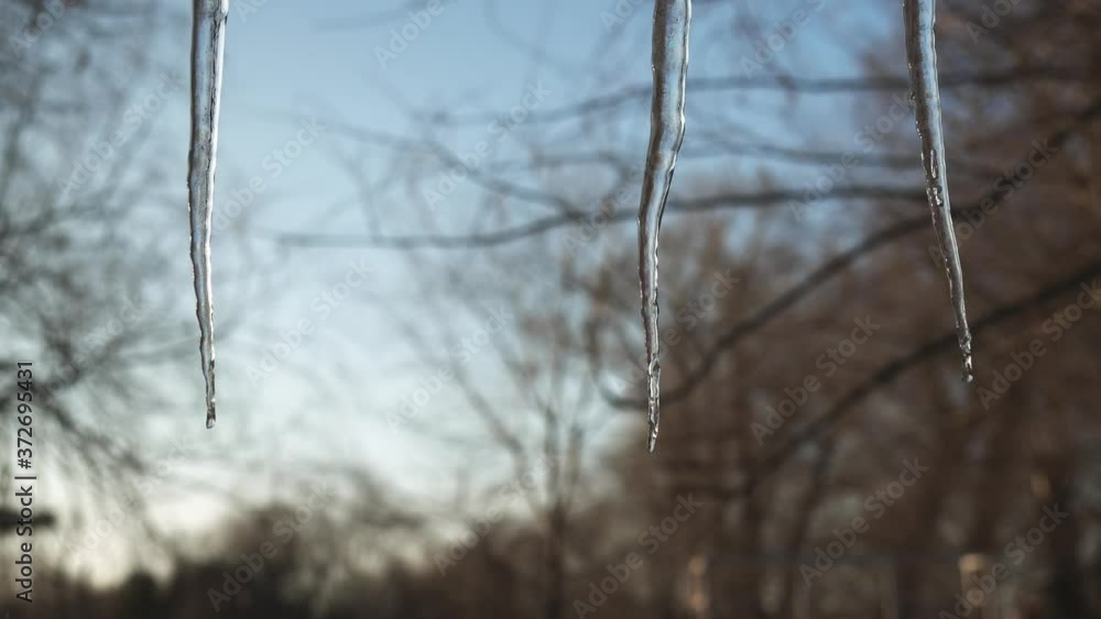 Male hand to rips off a hanging icicles close-up. Male hand to rips off a hanging icicles close-up.
