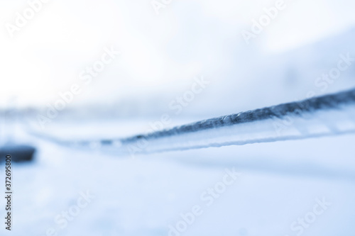 Frozen rope in winter. Huge icicles close up