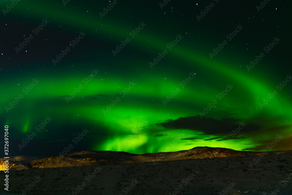Northern lights in the night sky of iceland. Soft focus. Magical green glow.