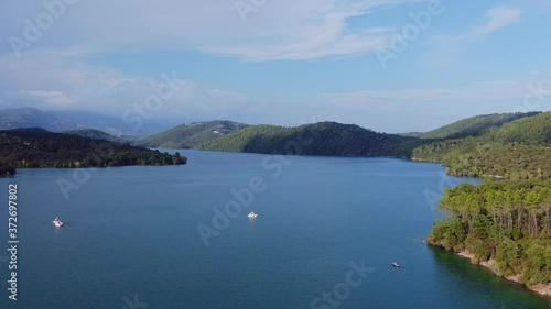 Wallpaper Mural Aerial view of the lake surrounded by many green trees with mountains in the background Torontodigital.ca