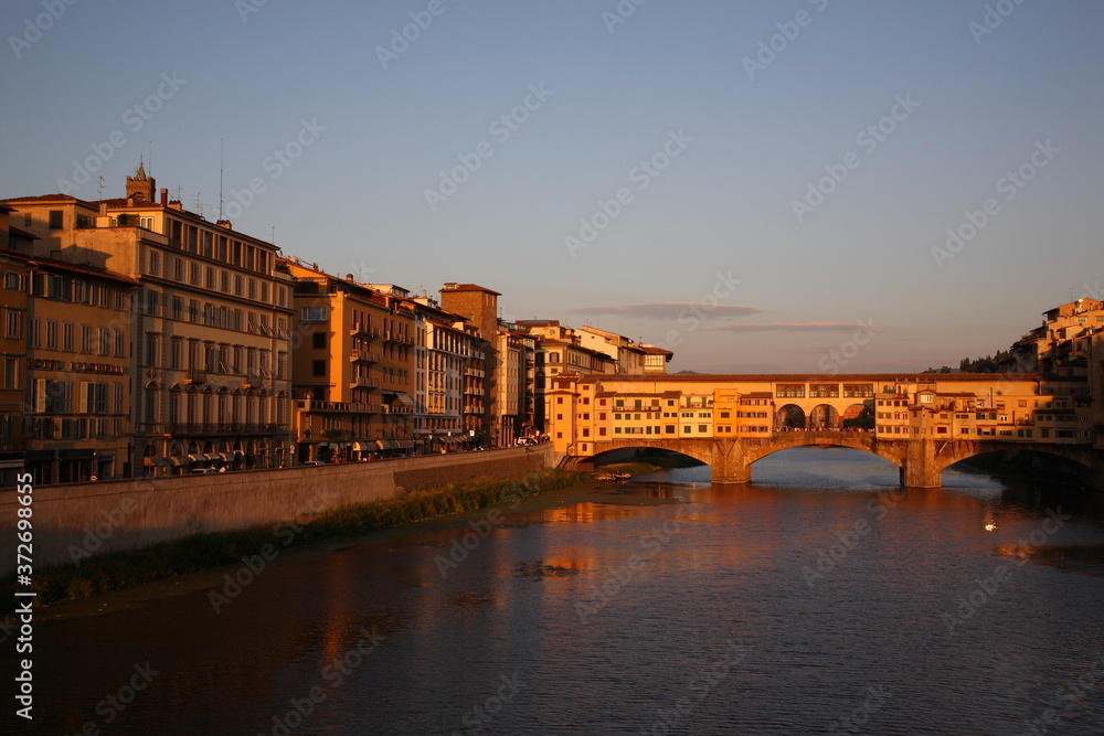 View of Ponte Vecchio bridge during sunset in Florence, Tuscany, Italy