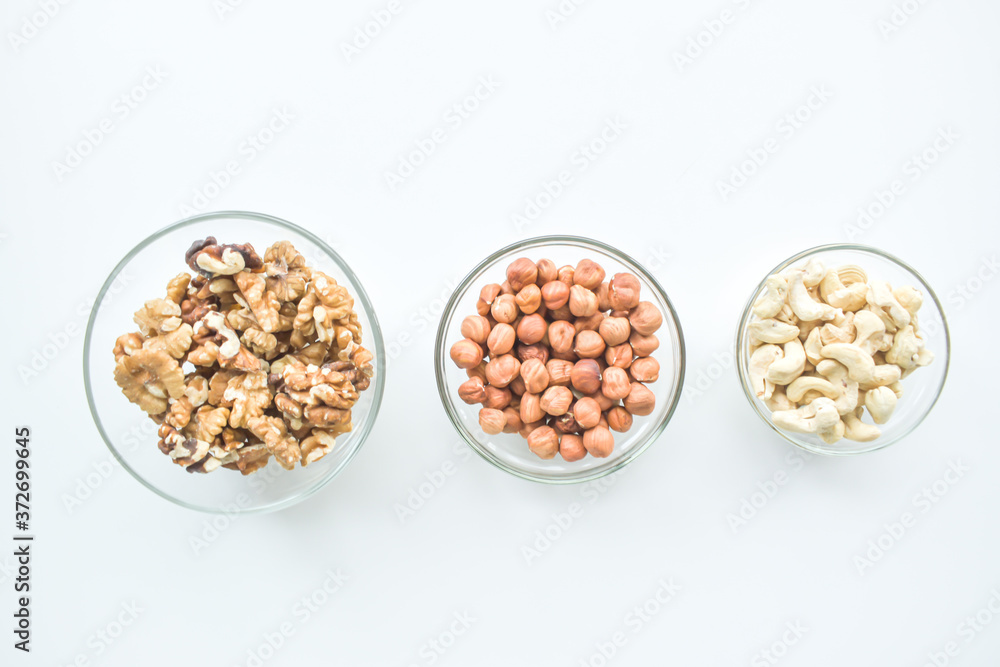 Hazelnuts, cashews, walnuts on a plate. Healthy food, vitamins omega 3, omega 6, calcium, magnesium. Hazelnuts, cashews, walnuts on a plate. Healthy food, vitamins omega 3, omega 6, calcium, magnesium.