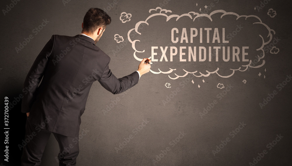 businessman drawing a cloud with CAPITAL EXPENDITURE inscription inside, modern business concept businessman drawing a cloud with CAPITAL EXPENDITURE inscription inside, modern business concept