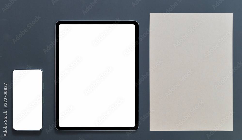 Mockup smartphone with tablet blank screen and brown note paper on black background, Top view shot. Mockup smartphone with tablet blank screen and brown note paper on black background, Top view shot.