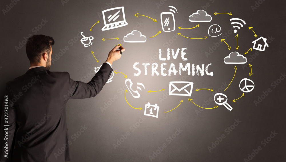 businessman drawing social media icons with LIVE STREAMING inscription, new media concept businessman drawing social media icons with LIVE STREAMING inscription, new media concept
