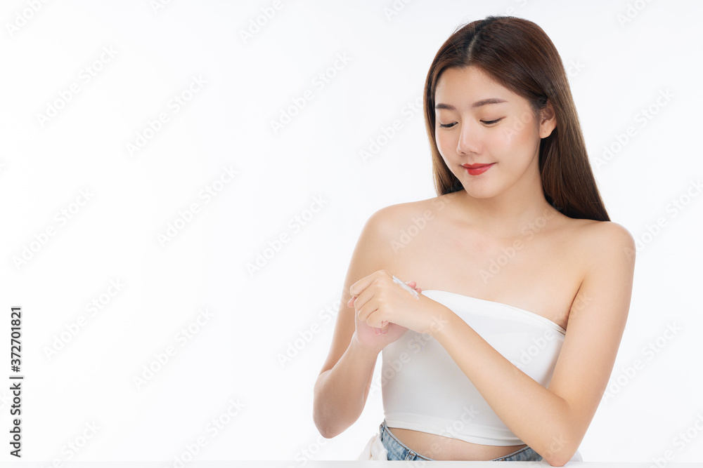 Portrait of smile young woman holding applying cosmetic cream or treatment moisturize in her hand for skin care on isolated on white background. Healthy skin and cosmetics concept. Portrait of smile young woman holding applying cosmetic cream or treatment moisturize in her hand for skin care on isolated on white background. Healthy skin and cosmetics concept.