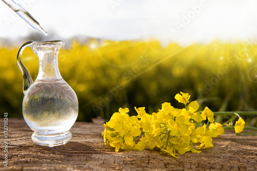 Oil glass jar and mustard seeds with flower