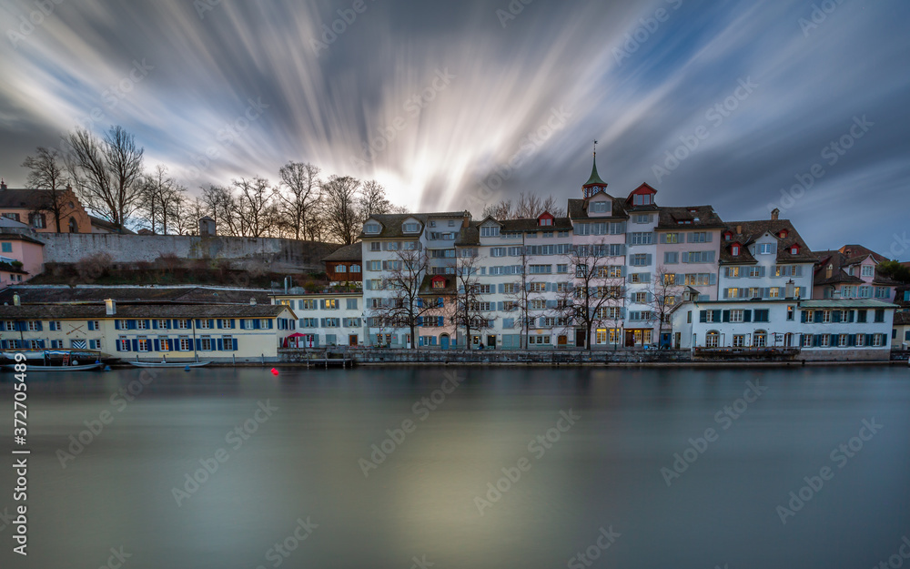 Obraz premium Limmat River at Sunset in Zürich, Switzerland. Panoramic long exposure of the view of historic Zurich city center and river Limmat , Switzerland Europe