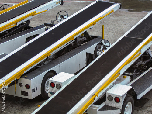 Luggage conveyor vehicles in row at the airport