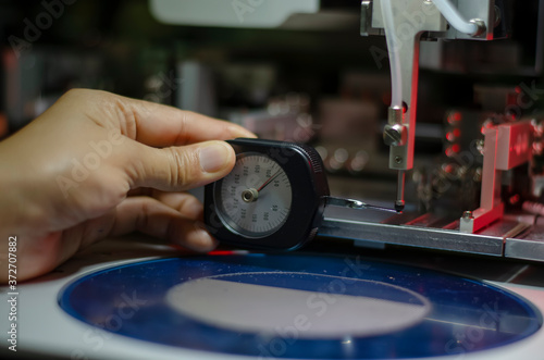 close up of a man holding a measuring machine