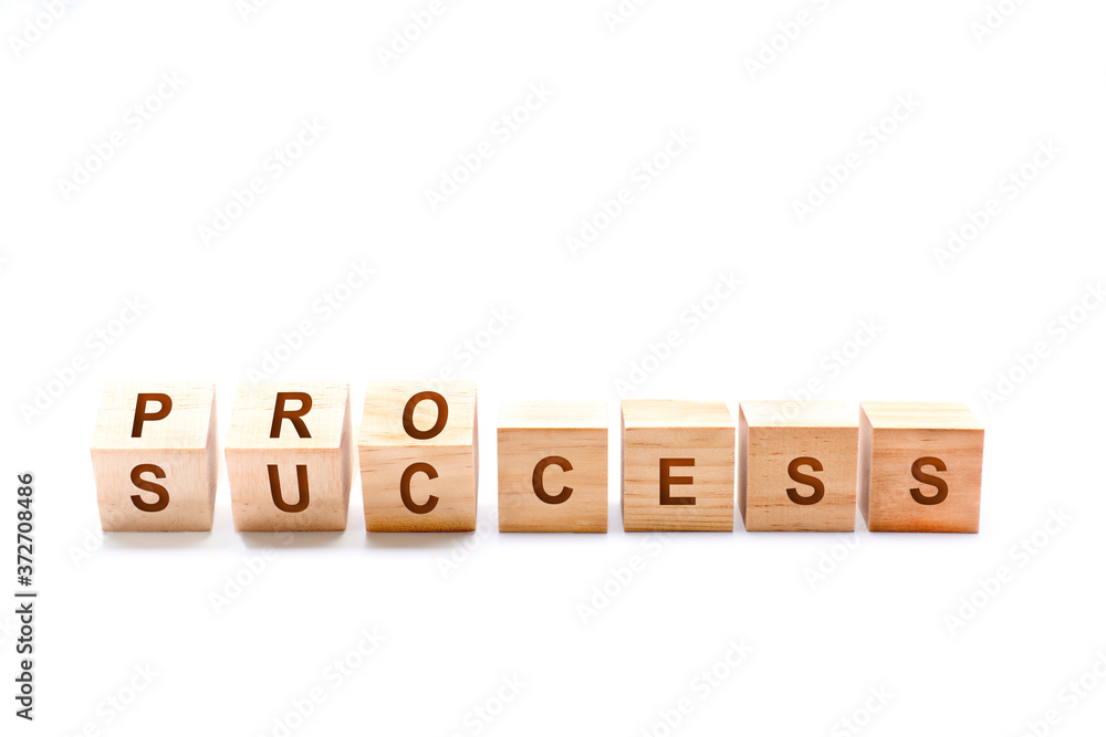 Wooden cube block flip over word process to success on wood table Wooden cube block flip over word process to success on wood table