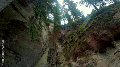 the Cliff of Sietiniezis Rock, Latvia. Gauja National Park. Pine Forest Tourist Trail With Pathwalk Near Sandstone Cliffs. photo