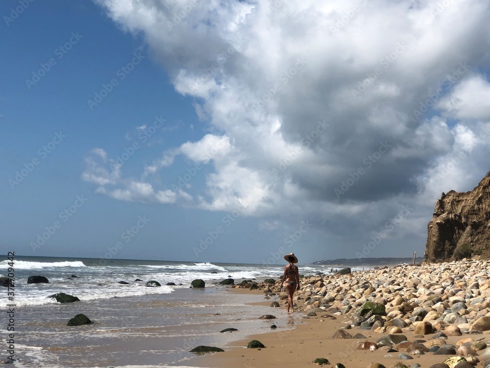 Woman walking on the beach alone